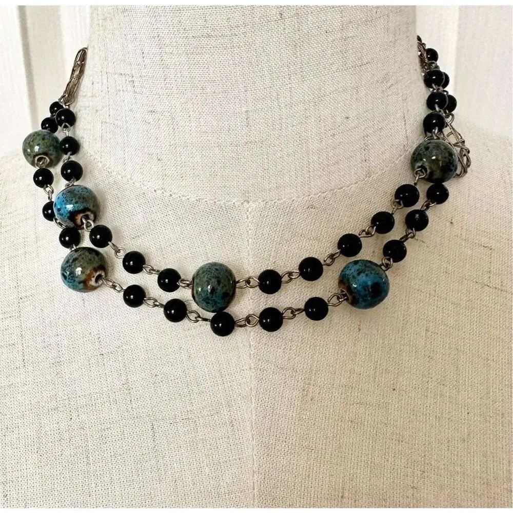 Long black silver tone and blue beaded necklace